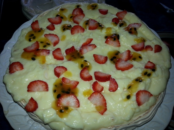 "Base" of the pavlova topped with the creme and fruit before the other layer went on.